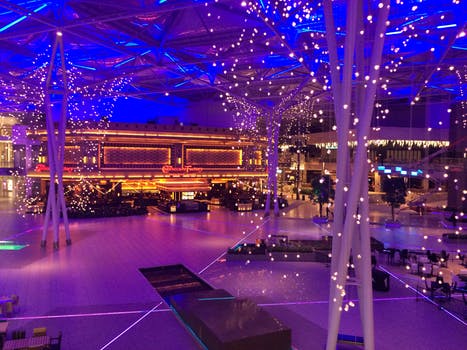 Stunning event structure being set up with fairy lights wrapped around the support poles and dance floor being installed.